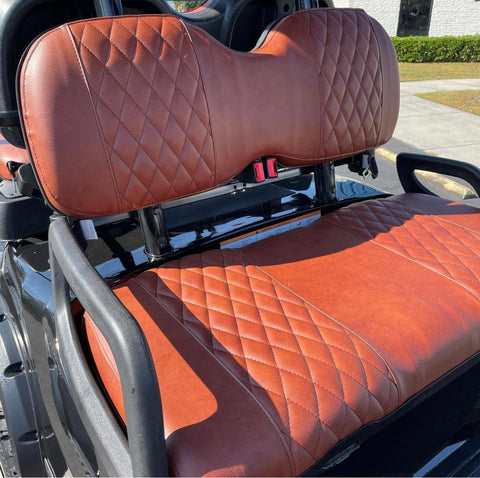 A tan diamond-stitched golf cart seat cover installed in a vehicle.